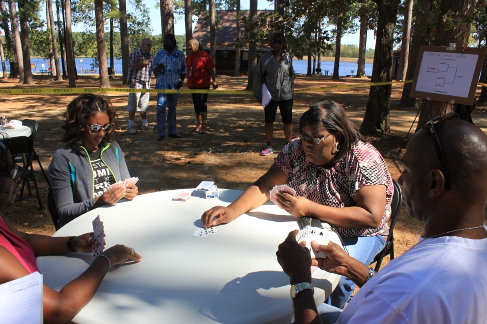 Turkieshiejia Nelson, Chanda Henderson, and Marshall Williams, DLA Distribution Red River, Texas, employees play spades at the annual Employee Appreciation Day on Oct.16.