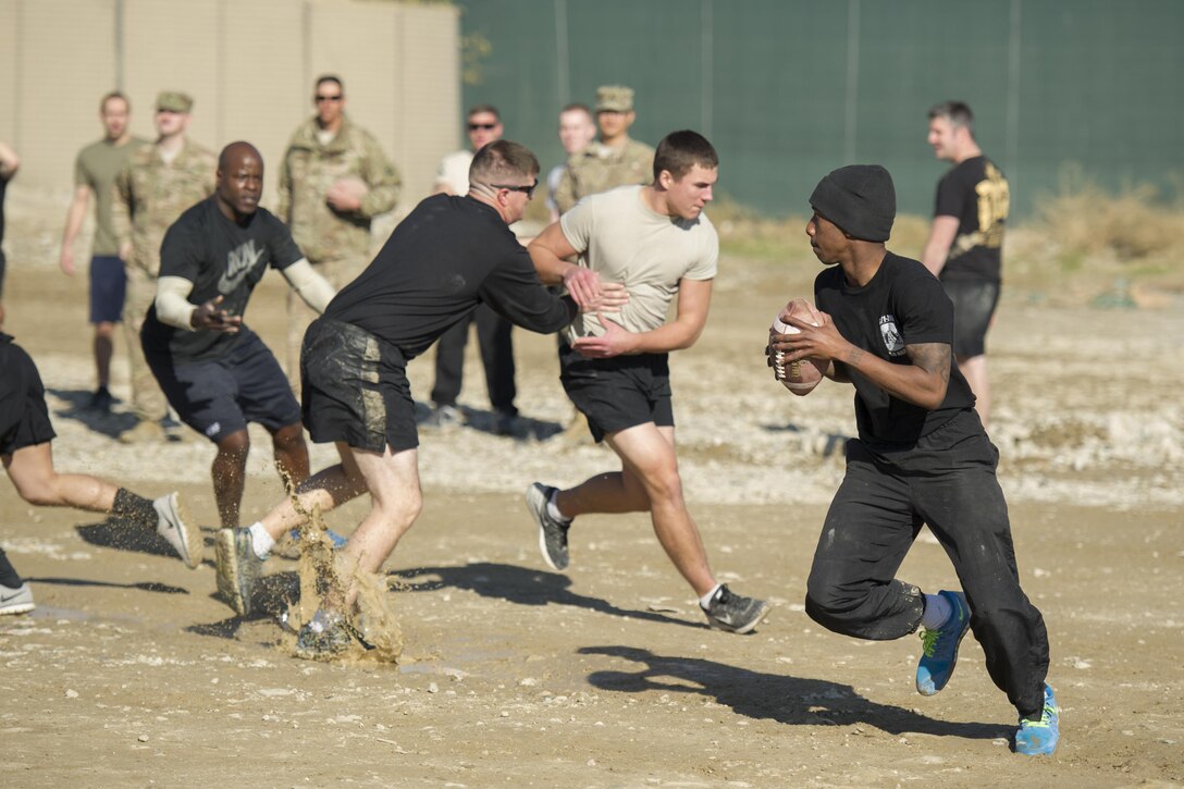 U.S. soldiers play U.S. airmen in a friendly "Turkey Bowl" football game on Bagram Airfield, Afghanistan, Nov. 26, 2015. The soldiers are assigned to Florida Army National Guard's 1st Battalion, 265th Air Defense Artillery Regiment, and the airmen are assigned to Florida Air National Guard's 290th Joint Communications Support Squadron. The Army team won the game 42-35. U.S. Air Force photo by Tech. Sgt. Robert Cloys