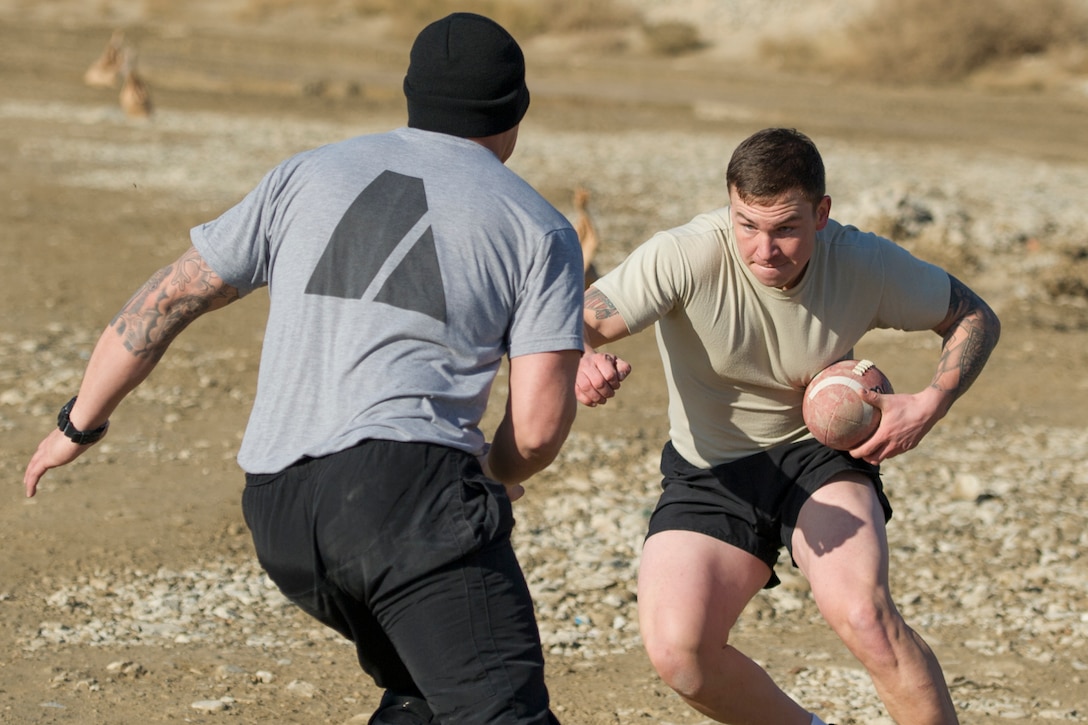 U.S. soldiers play U.S. airmen in a friendly "Turkey Bowl" football game on Bagram Airfield, Afghanistan, Nov. 26, 2015. The soldiers are assigned to Florida Army National Guard's 1st Battalion, 265th Air Defense Artillery Regiment, and the airmen are assigned to Florida Air National Guard's 290th Joint Communications Support Squadron. The Army team won the game 42-35. U.S. Air Force photo by Tech. Sgt. Robert Cloys