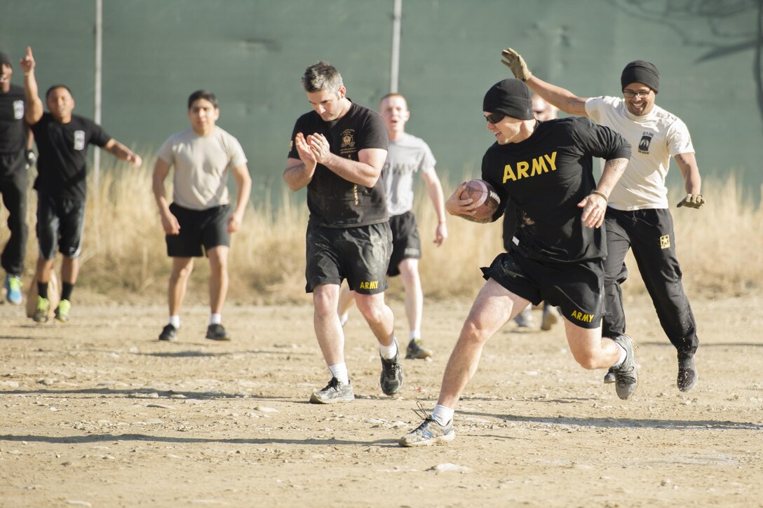 U.S. soldiers play U.S. airmen in a friendly "Turkey Bowl" football game on Bagram Airfield, Afghanistan, Nov. 26, 2015. The soldiers are assigned to Florida Army National Guard's 1st Battalion, 265th Air Defense Artillery Regiment, and the airmen are assigned to Florida Air National Guard's 290th Joint Communications Support Squadron. The Army team won the game 42-35. U.S. Air Force photo by Tech. Sgt. Robert Cloys