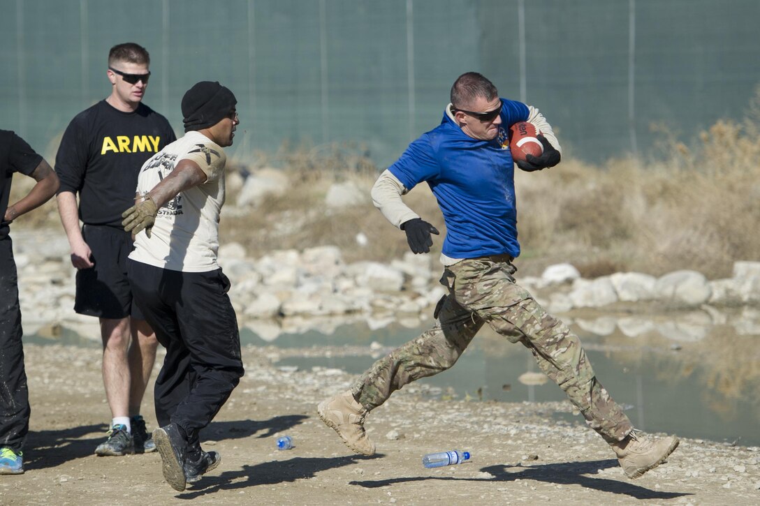 U.S. soldiers play U.S. airmen in a friendly "Turkey Bowl" football game on Bagram Airfield, Afghanistan, Nov. 26, 2015. The soldiers are assigned to Florida Army National Guard's 1st Battalion, 265th Air Defense Artillery Regiment, and the airmen are assigned to Florida Air National Guard's 290th Joint Communications Support Squadron. The Army team won the game 42-35. U.S. Air Force photo by Tech. Sgt. Robert Cloys.