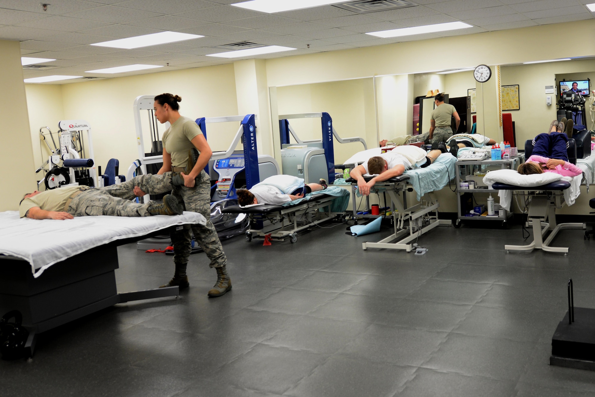 Staff Sgt. Amber Coley, 4th Medical Operations Squadron physical therapy technician, provides assistance to several patients, Nov. 18, 2015, in the physical therapy clinic at Seymour Johnson Air Force Base, North Carolina. Team Seymour’s physical therapists see more than 100 patients per week, instructing them on different exercises to rehabilitate their injuries. (U.S. Air Force photo/Airman 1st Class Ashley Williamson)