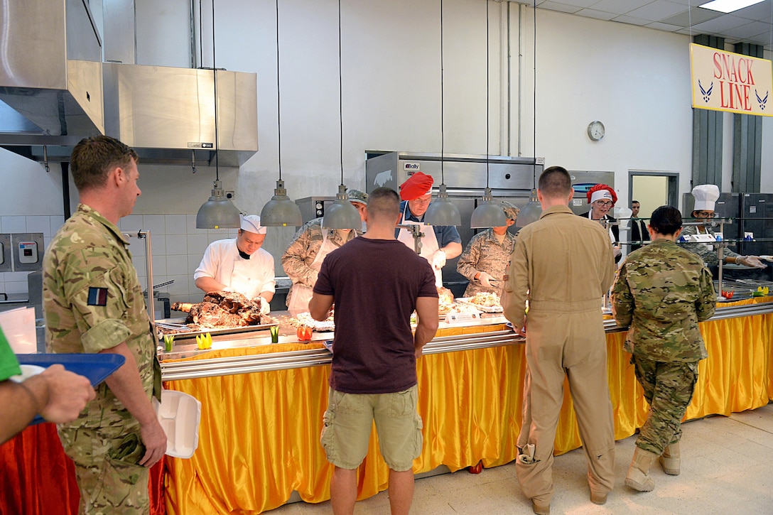 U.S. Deputy Defense Secretary Bob Work, and his wife, Cassandra, serve Thanksgiving dinner to service members on Al Udeid Air Base, Qatar, Nov. 26, 2015. DoD photo by Army Sgt. 1st Class Clydell Kinchen
