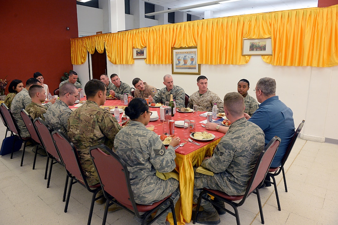 U.S. Deputy Defense Secretary Bob Work, right, and his wife, Cassandra, left back, sit with service members to share a Thanksgiving meal on Al Udeid Air Base, Qatar, Nov. 26, 2015. DoD photo by Army Sgt. 1st Class Clydell Kinchen