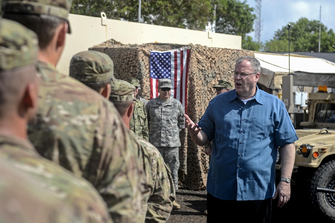U.S. Deputy Defense Secretary Bob Work discusses Defense Department changes with U.S. soldiers on Camp Lemonnier, Djibouti, Nov. 26, 2015. The soldiers, members of a quick-response unit, are assigned to the Florida Army National Guard's Company D, 2nd Battalion, 124th Infantry Regiment. U.S. Air Force photo by Senior Airman Peter Thompson