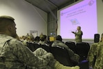 U.S. Army Gen. Frank J. Grass, chief of the National Guard Bureau, introduces himself to an audience of more than 200 reserve-component Service members during a town hall event at Camp Bondsteel, Kosovo, Nov. 24, 2015.