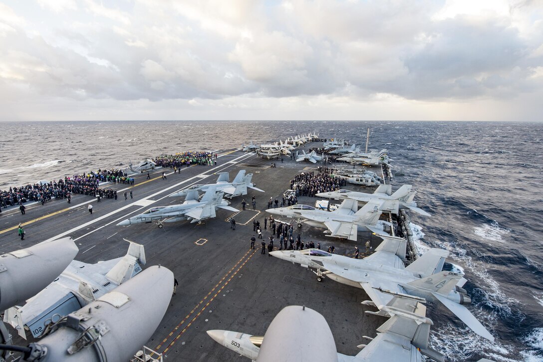 U.S. sailors participate in an abandon ship drill on the flight deck of the aircraft carrier USS Dwight D. Eisenhower in the Atlantic Ocean, Nov. 26, 2015. The carrier, with embarked Carrier Air Wing 3, is conducting an evaluation as part of a fleet response plan. U.S. Navy photo by Seaman Anderson W. Branch