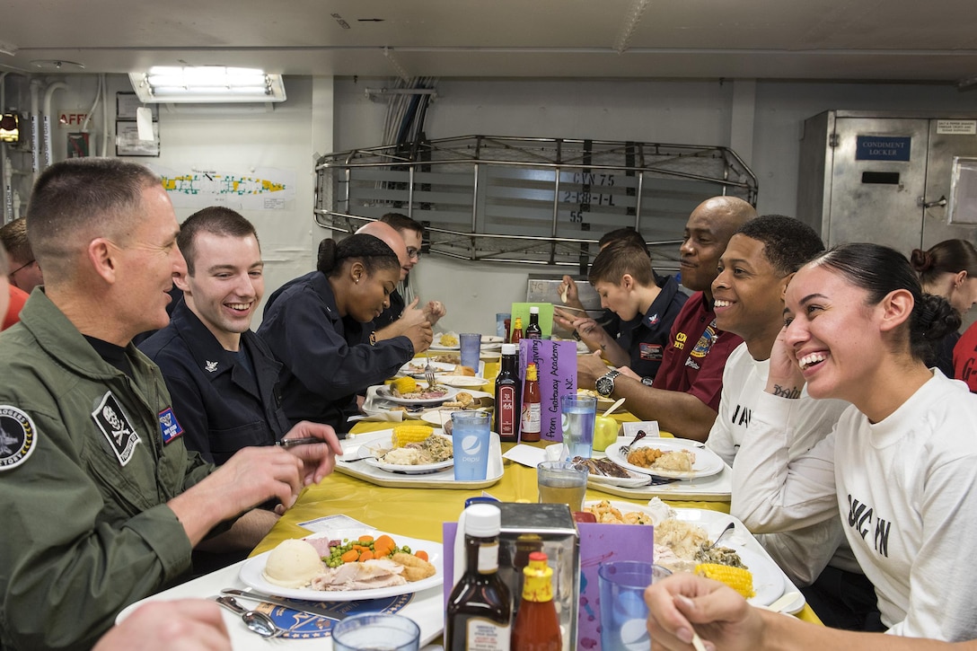 Master Chief Petty Officer of the Navy Michael D. Stevens shares Thanksgiving dinner with sailors on the mess decks aboard the aircraft carrier USS Harry S. Truman in the Atlantic Ocean, Nov. 26, 2015. The Harry S. Truman Carrier Strike Group is supporting maritime security operations and theater security cooperation efforts in the areas of operation for the U.S. 5th and 6th fleets. U.S. Navy photo by Petty Officer 3rd Class A. Cruz