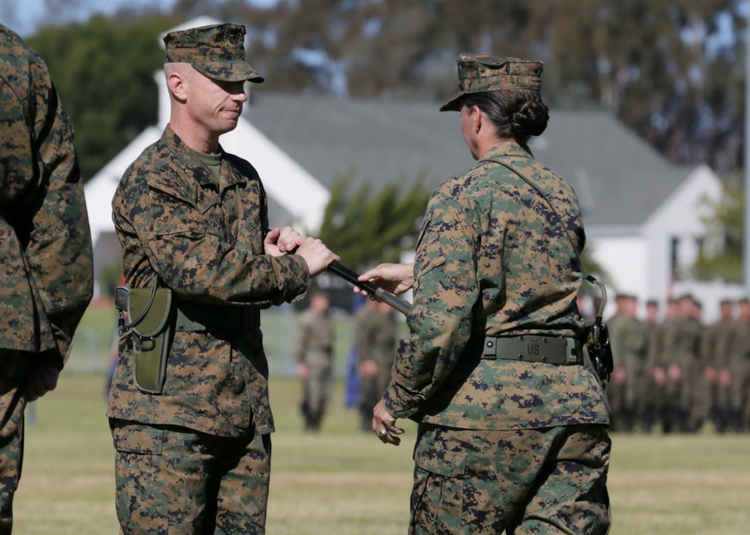 Sgt. Maj. David A. Wilson, sergeant major of I Marine Expeditionary Force Headquarters Group, I MEF, receives the ceremonial noncommissioned officer sword from Col. Roberta L. Shea, the commanding officer of I MHG, during a relief and appointment ceremony aboard Marine Corps Base Camp Pendleton, California, Nov. 19, 2015. Wilson was formerly the sergeant major of Marine Wing Support Squadron 371. ( U.S. Marine Corps photo by Lance Cpl. Timothy Valero)