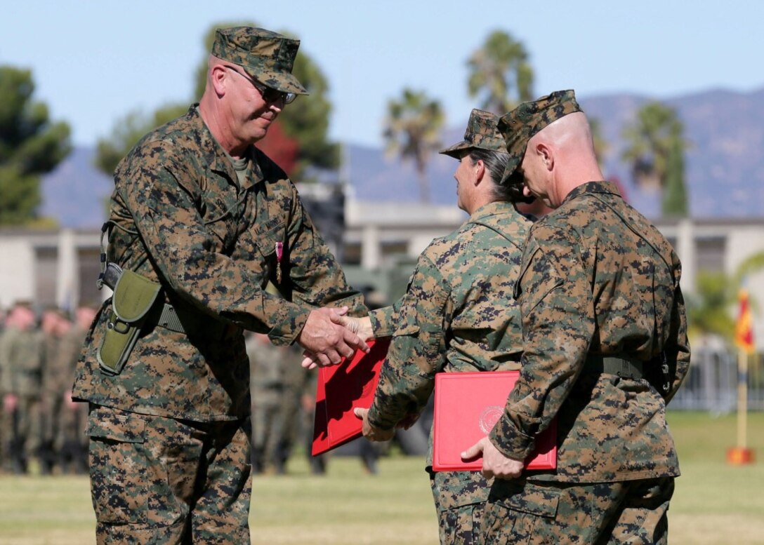 Sgt. Maj. Darryl J. Sisneros, the former sergeant major I Marine Expeditionary Force Headquarters Group, I MEF, shakes Col. Roberta L. Shea’s hand after receiving the Legion of Merit, awarded for meritorious conduct and outstanding service, during a relief and appointment ceremony aboard Marine Corps Base Camp Pendleton, California, Nov. 19, 2015. Col. Roberta L. Shea is commanding officer of I MHG. Sisneros relinquished his duties as sergeant major of I MHG, to Sgt. Maj. David A. Wilson. 
(U.S. Marine Corps photo by Lance Cpl. Timothy Valero)