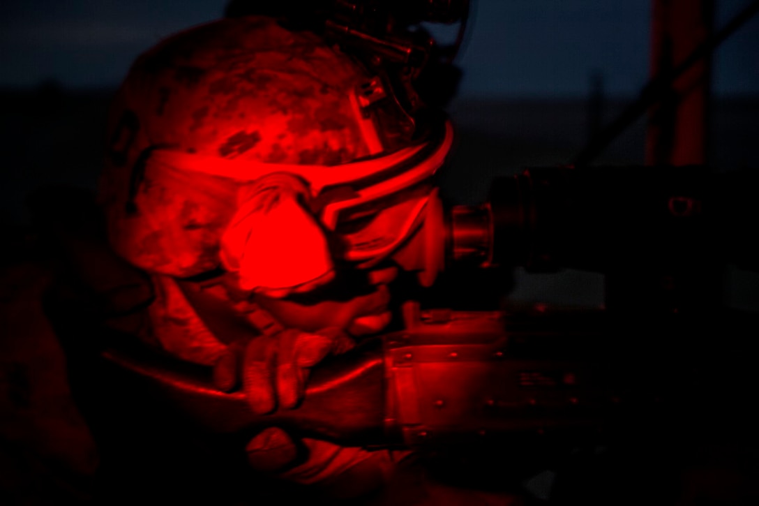 U.S. Marine Lance Cpl. Terence Clayborne, a rifleman with 1st Battalion, 7th Marine Regiment, Special Purpose Marine Air Ground Task Force-Crisis Response-Central Command, searches from his post for possible threats during a mission readiness exercise at an undisclosed location Nov. 24, 2015. Clayborne reported various threats and anomalies during the exercise to hone his skills for potential missions in the Central Command area of responsibility. (U.S. Marine Corps Photo by Sgt. Owen Kimbrel / Released)