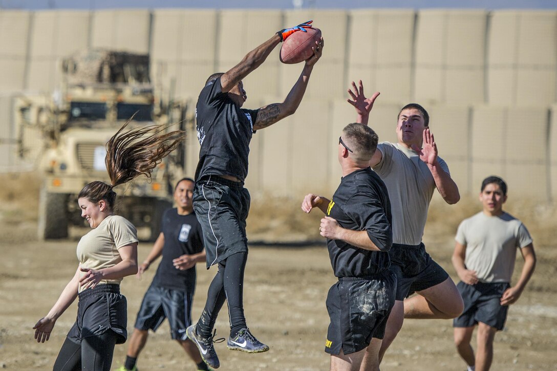 U.S. soldiers play U.S. airmen in a friendly "Turkey Bowl" football game on Bagram Airfield, Afghanistan, Nov. 26, 2015. The soldiers are assigned to Florida Army National Guard's 1st Battalion, 265th Air Defense Artillery Regiment, and the airmen are assigned to Florida Air National Guard's 290th Joint Communications Support Squadron. The Army team won the game 42-35. U.S. Air Force photo by Tech. Sgt. Robert Cloys