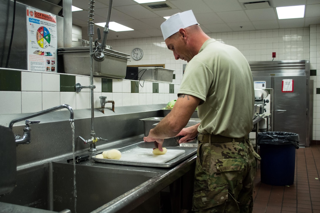 A Green Beret dices potatoes as he prepares a Thanksgiving dinner in the unit’s dining facility on Eglin Air Force Base, Fla., Nov. 23, 2015. U.S. Army photo by Maj. Thomas Cieslak