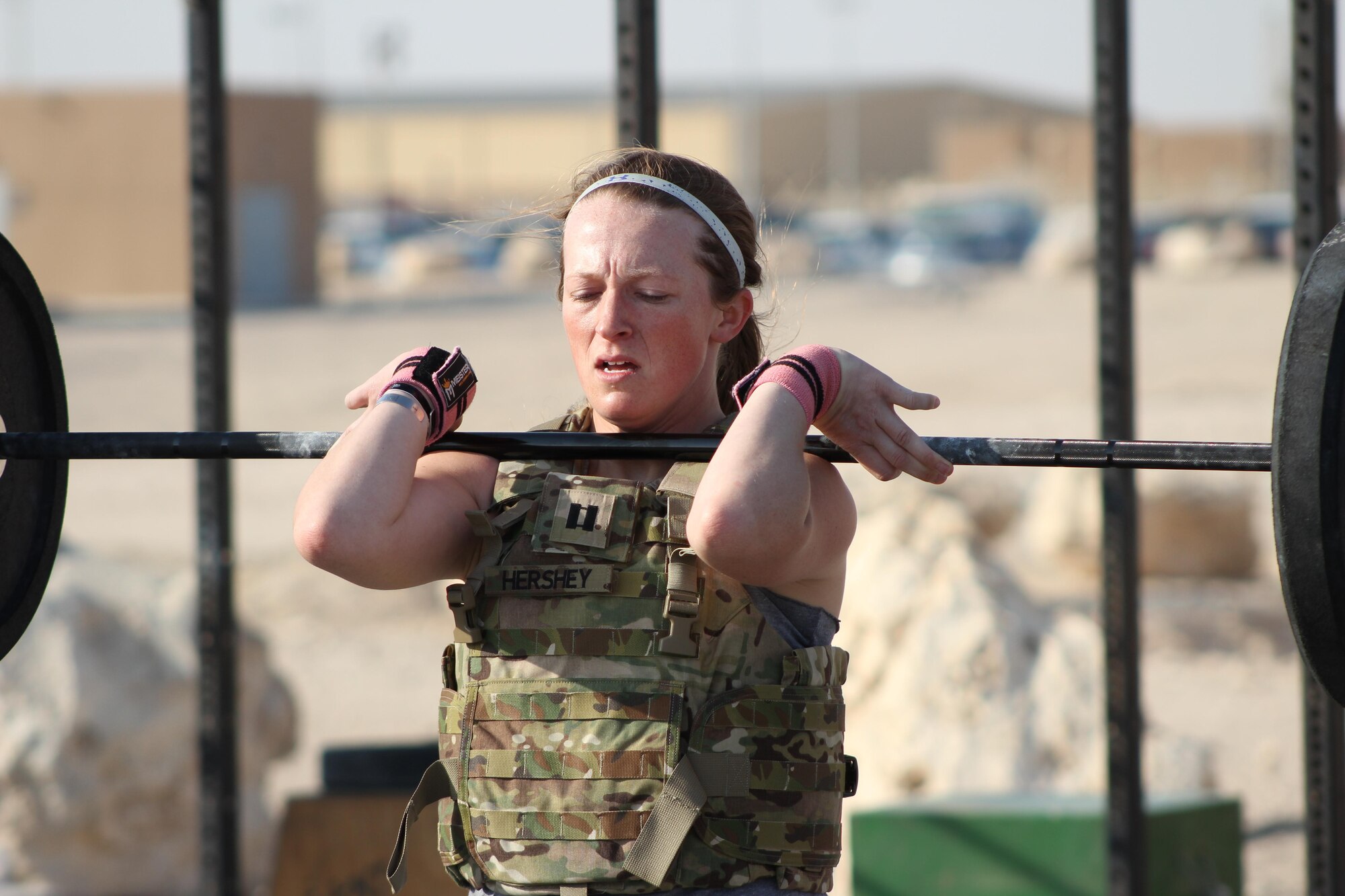 Service members participated in the EOD 130 Memorial Workout outside the BPC gym at Al Udeid Air Base, Qatar. Working as a two man team participants performed weighted squats with their partners for a combined total of 65. (U.S Air Force photo courtesy of Master Sgt. Leonard Campbell Jr.)