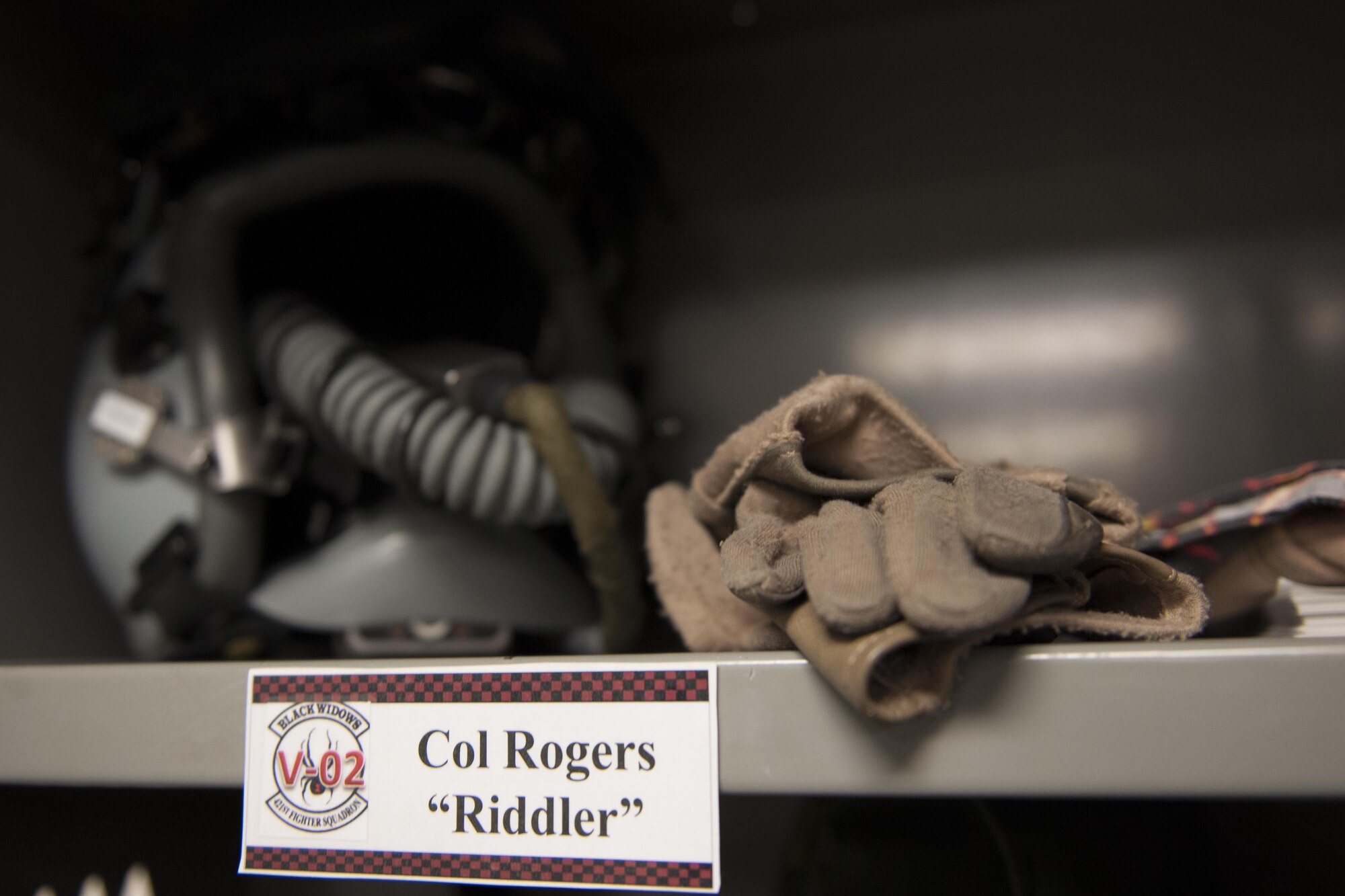 455th Operation Group Commander Col. Henry Rogers' helmet and gloves sit in locker at the 421st Expeditionary Fighter Squadron at Bagram Airfield, Afghanistan, Nov. 27, 2015. Rogers became one of only a couple-hundred F-16 pilots worldwide to surpass 3,000 flying hours in the F-16 on Oct. 29, 2015. He followed that up with reaching 1,000 combat hours in the fighter workhorse on Nov. 7, 2015. (U.S. Air Force photo by Tech. Sgt. Robert Cloys/Released)
