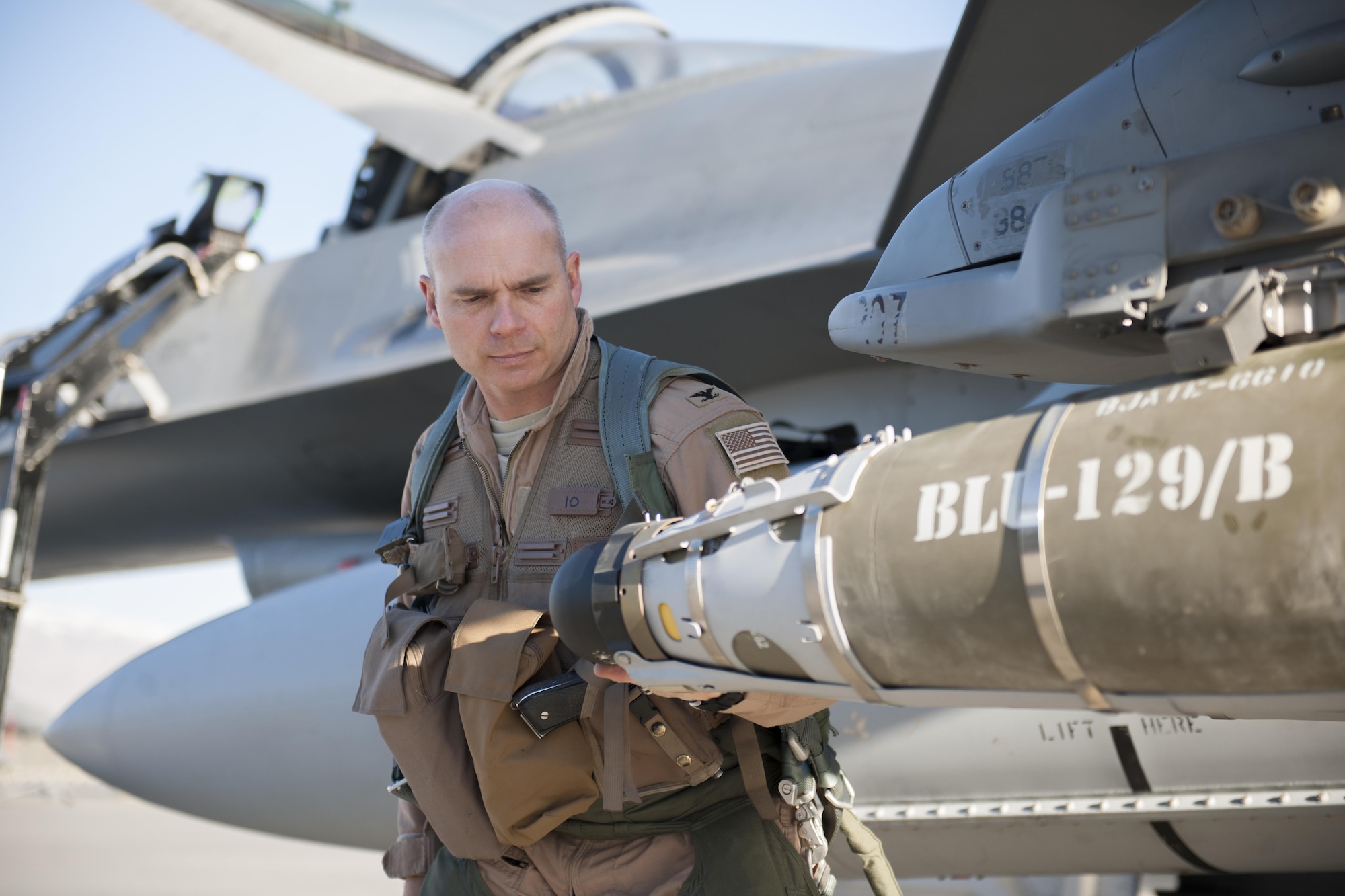 Col. Henry Rogers, 455th Expeditionary Operations Group commander, perfoms pre-flight inspections on an F-16 Fighting Falcon before a sortie with the 421st Expeditionary Fighter Squadron at Bagram Airfield, Afghanistan, Nov. 27, 2015. Rogers reached the 3,000-flying hour milestone and 1,000 combat-hour milestone while serving on his eighth combat deployment flying F-16s. (U.S. Air Force photo by Tech. Sgt. Robert Cloys/Released)