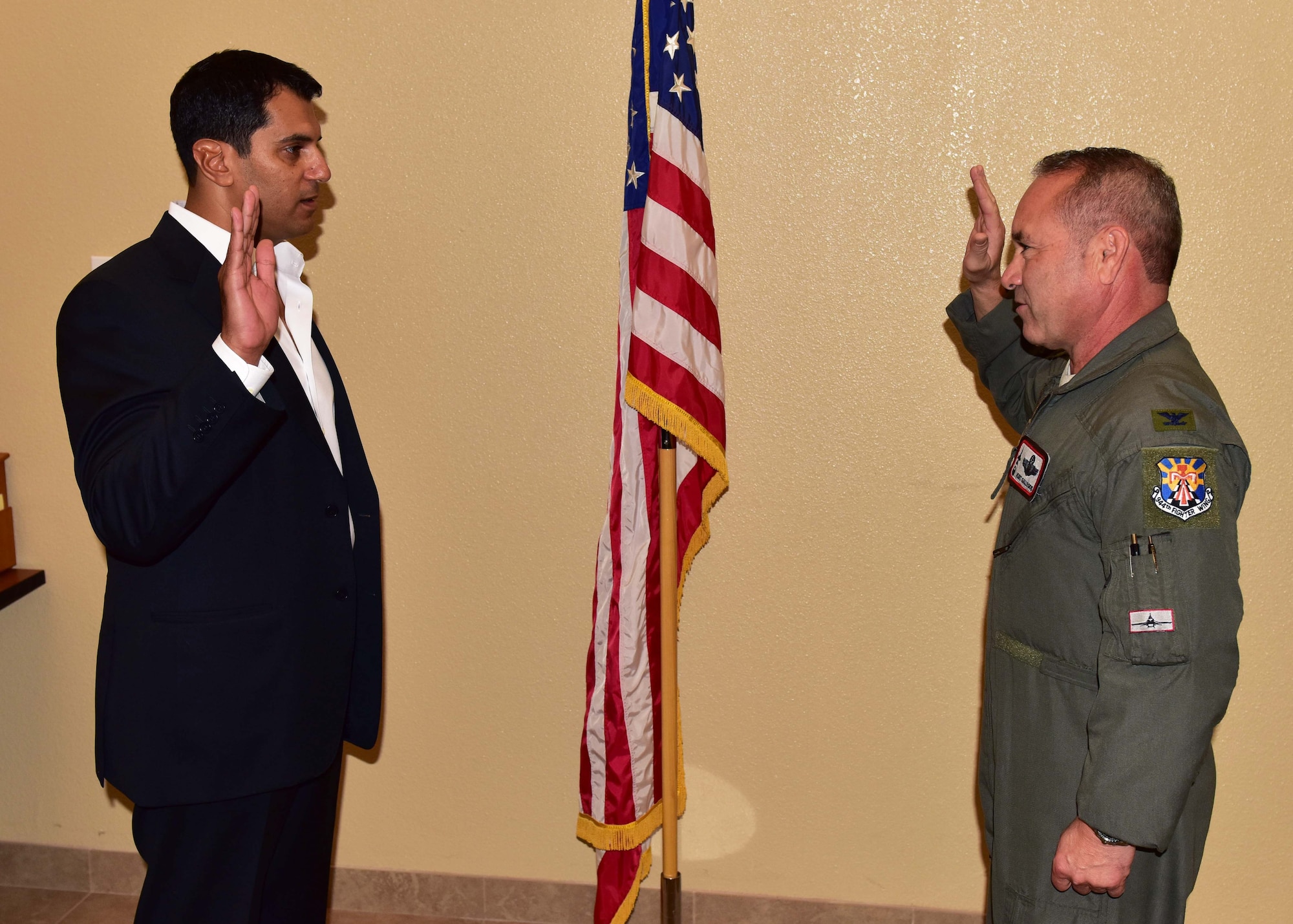 Dr. John Beshai, Arizona Mayo Clinic cardiologist and senior associate consultant, raises his right hand while Col. Kurt Gallegos, 944th Fighter Wing commander, tenders the Oath of Office during a short ceremony and welcomed Beshai to the unit Oct. 24, at Luke Air Force Base, Ariz. (U.S. Air Force photo taken by Tech. Sgt. Louis Vega Jr.)