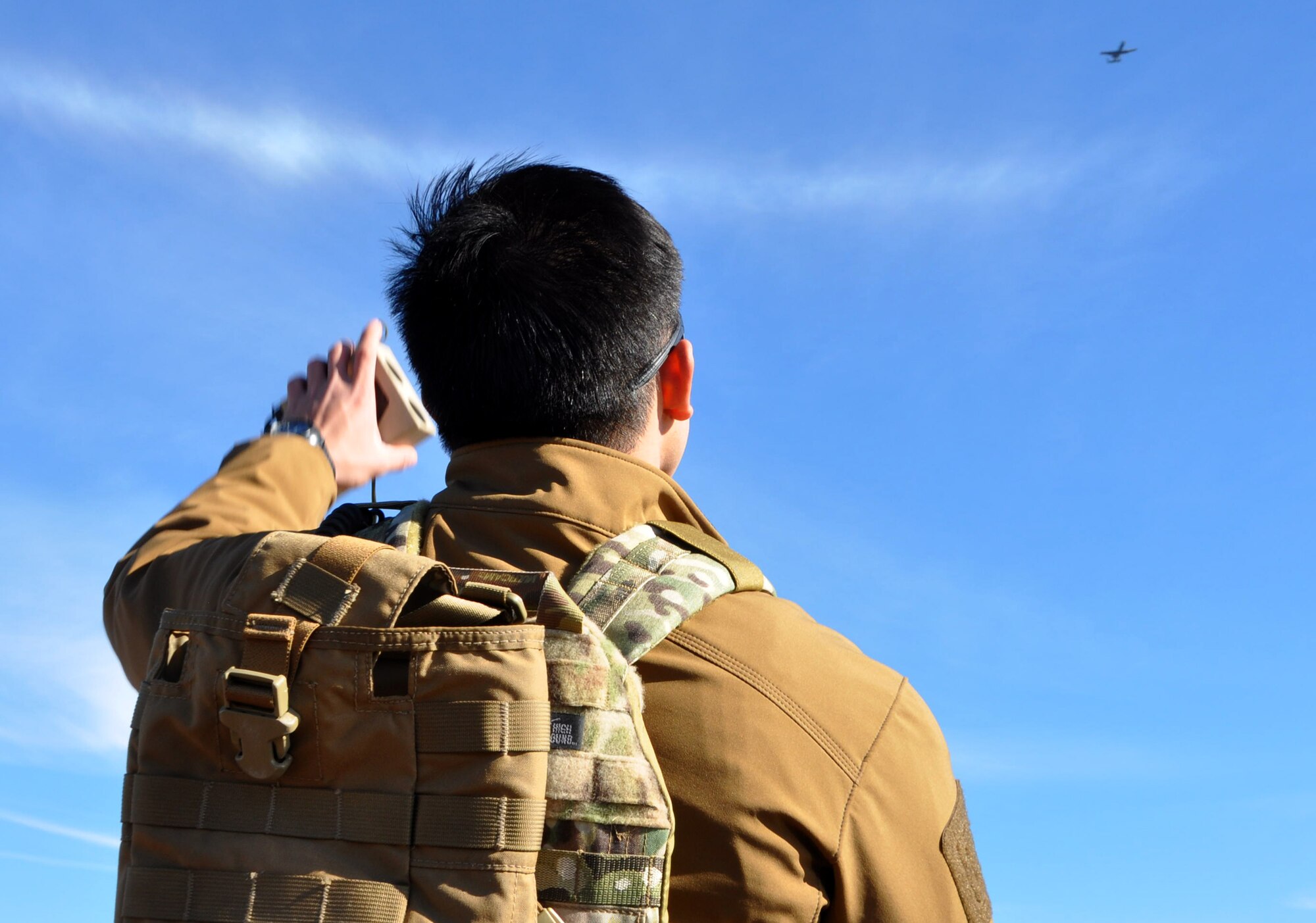 Airman 1st Class Kavin Tayaq, a student JTAC, signals an A-10 Thunderbolt II aircraft from the 442d Fighter Wing as part of their field training exercise south of Warsaw, Missouri on 19 November. Academic portions of the class rely on JTACs playing the role of pilots in hypothetical missions, but the exercise gives students the opportunity to speak with experienced pilots from the 442d Fighter Wing over the radio in realistic scenarios. Warsaw has hosted the exercises since 1993. (U.S. Air Force photo/ Technical Sgt. Emily F. Alley)