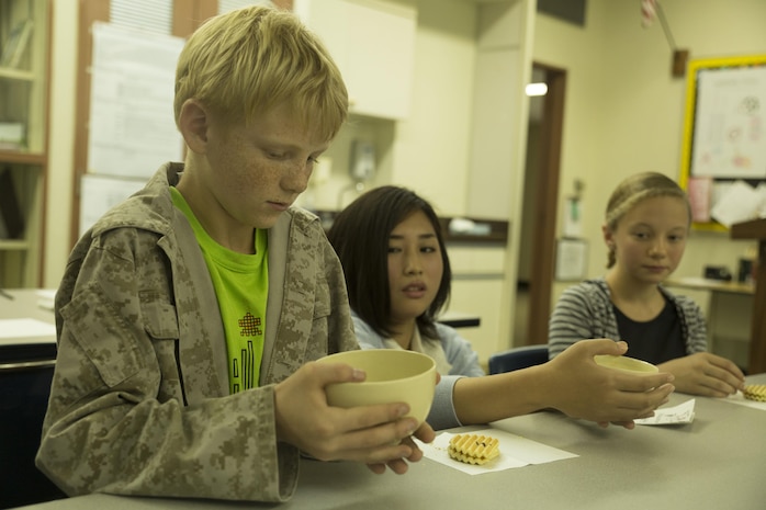 Matthew Payne Hageter, a student at Matthew C. Perry High School, prepares to drink a freshly brewed cup of green tea during a visit with students from the Bunkyo Women’s University in Hiroshima, Japan, at Marine Corps Air Station Iwakuni, Nov. 23, 2015. Bunkyo Women’s University students taught the students of M.C. Perry about various Japanese traditions. Interactions like these help educate students from both schools on each other’s cultures promoting respect and understanding for one another.