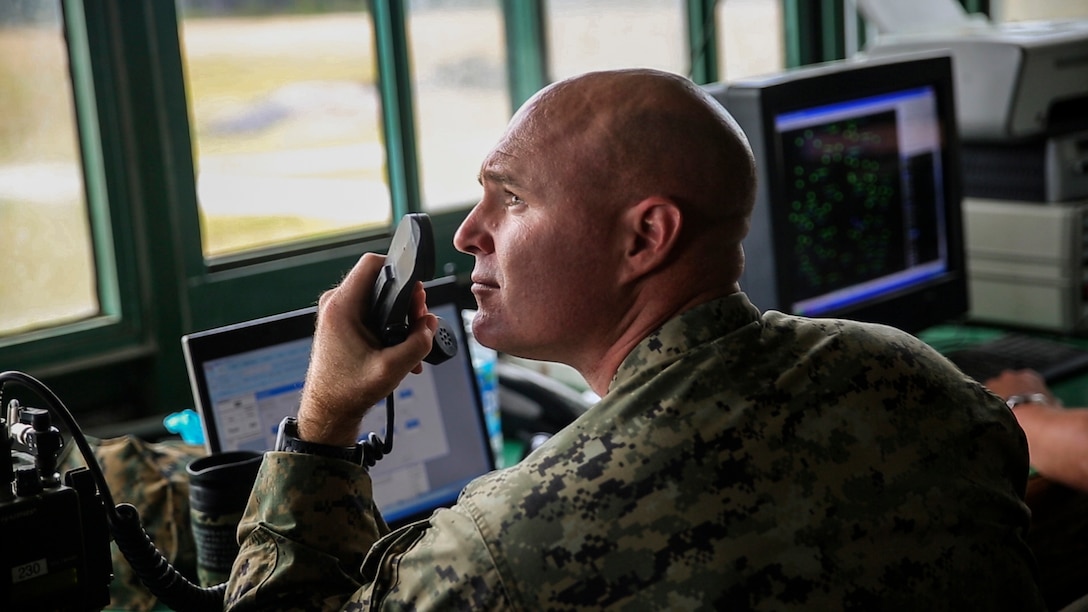 Gunnery Sgt. Michael Connors, a master gunner with 2nd Assault Amphibian Battalion, gives radio commands to the Amphibious Assault Vehicle crews during a Heavy Brigade Combat Team qualification at Marine Corps Base Camp Lejeune, North Carolina, Nov. 19, 2015.  The qualification is a course of fire that requires crews to engage several targets while taking time and accuracy into account, and trying to score a possible 1,000 points. 