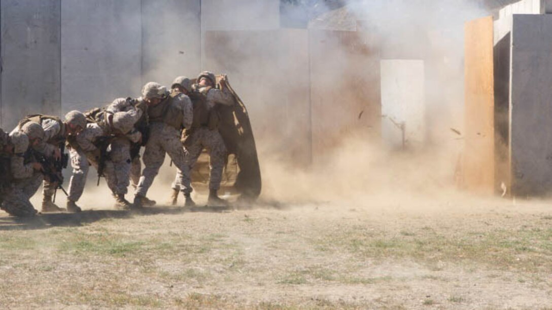 Marines with I Marine Expeditionary Force detonate a charge while practicing explosive breach during the Urban Leaders Course at Marine Corps Base Camp Pendleton, California, Oct. 30, 2015. Prior to the breach, the front man shielded the Marines from the explosion in order to prevent injury from the debris.