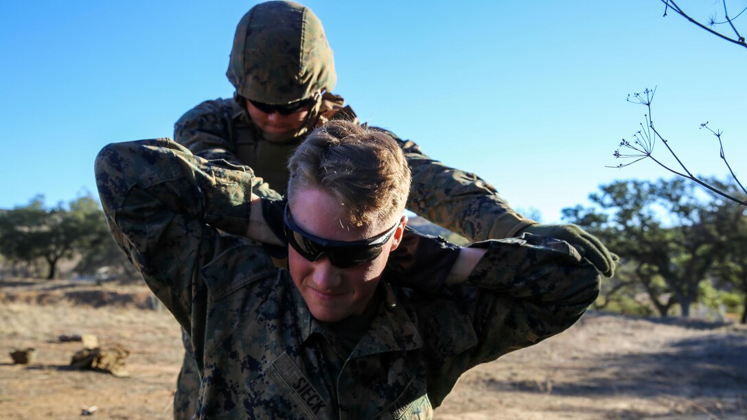 Lance Cpl. Sean Sims, a Huntington, Texas, native and landing support specialist with Combat Logistics Battalion 11, 1st Marine Logistics Group, detains and searches a fellow Marine, posing as a simulated threat, as part of the Basic Combat Skills Course at Marine Corps Base Camp Pendleton, Calif., Nov. 20, 2015. BCSC serves as a refamiliarization course for non-infantry Marines, teaching the fundamental skills needed to operate in a combat zone.