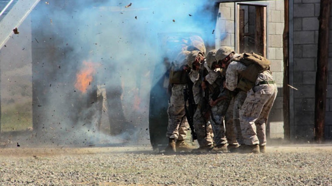 Lance Cpl. Taylor Drake, a combat engineer with 1st Combat Engineer Battalion, 1st Marine Division, breaches a door with an oval charge at Marine Corps Base Camp Pendleton, California, Drake, a Phoenix native, conducted breaching and room clearing drills with 2nd Platoon, Bravo Company, 1st CEB Marines, Oct. 8, 2015.