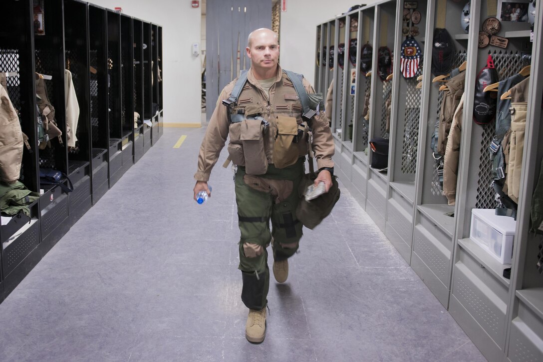 U.S. Air Force Col. Henry Rogers walks through the locker room at the 421st Expeditionary Fighter Squadron on Bagram Airfield, Afghanistan, Nov. 27, 2015. Rogers, the group commander, 455th Expeditionary Operations, reached the 3,000-flying hour and 1,000 combat-hour milestones while serving on his eighth combat deployment flying F-16 aircraft. U.S. Air Force photo by Tech. Sgt. Robert Cloys