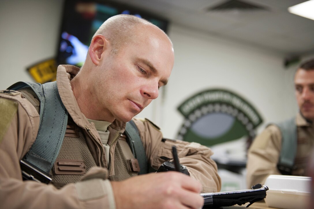 U.S. Air Force Col. Henry Rogers, 421st Expeditionary Fighter Squadron, takes notes during a mission brief at Bagram Airfield, Afghanistan, Nov. 27, 2015. U.S. Air Force photo by Tech. Sgt. Robert Cloys