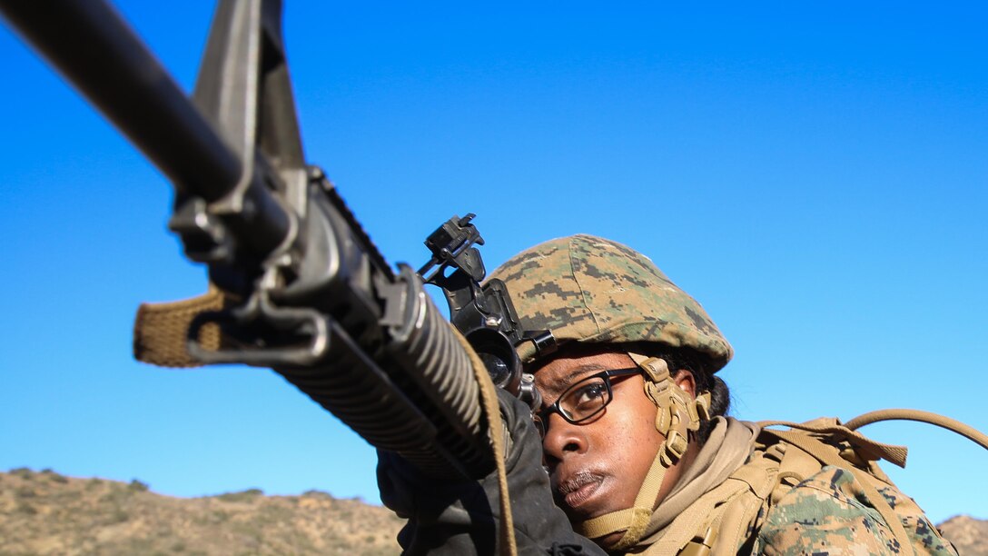 Lance Cpl. Alyse Griffis, a Detroit native and a landing support specialist with Combat Logistics Battalion 11, 1st Marine Logistics Group, provides security for her fellow Marines during a squad rushing drill as part of the Basic Combat Skills Course at Marine Corps Base Camp Pendleton, Calif., Nov. 20, 2015. BCSC serves as a refamiliarization course for non-infantry Marines, teaching the fundamental skills needed to operate in a combat zone.