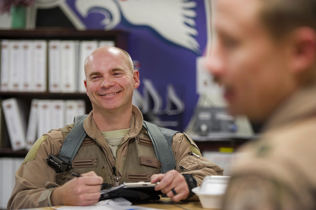 U.S. Air Force Col. Henry Rogers,  421st Expeditionary Fighter Squadron, left, takes notes during a mission brief at Bagram Airfield, Afghanistan, Nov. 27, 2015. U.S. Air Force photo by Tech. Sgt. Robert Cloys