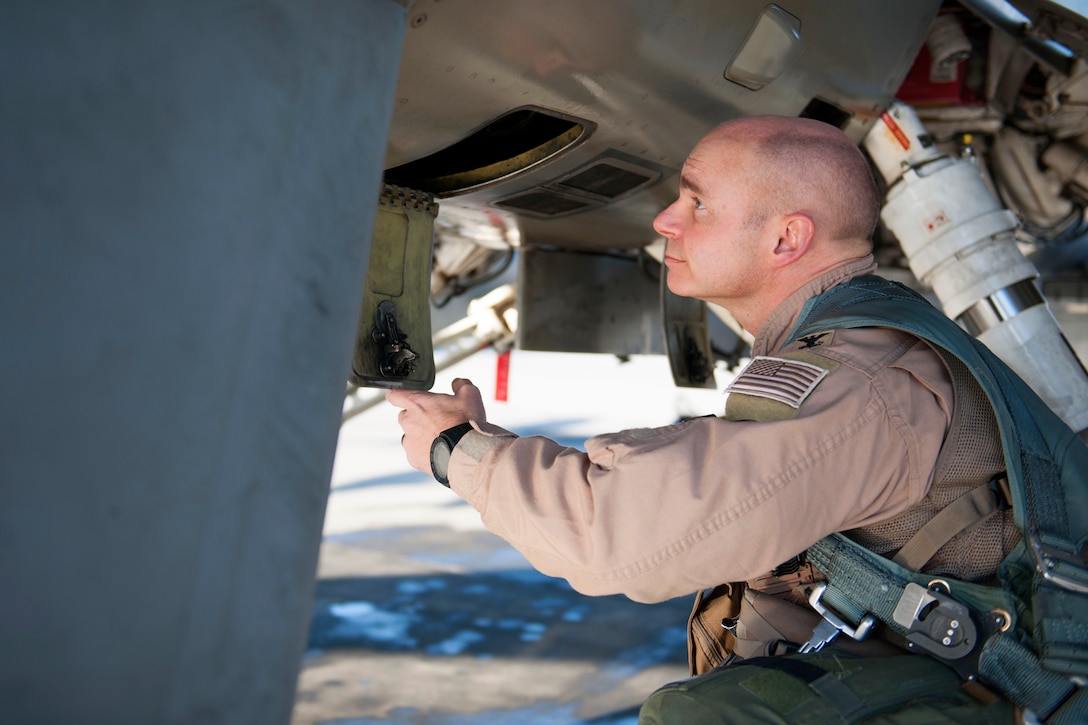 U.S. Air Force Col. Henry Rogers, 421st Expeditionary Fighter Squadron, conducts pre-flight inspections on an F-16 Fighting Falcon aircraft at Bagram Airfield, Afghanistan, Nov. 27, 2015. U.S. Air Force photo by Tech. Sgt. Robert Cloys