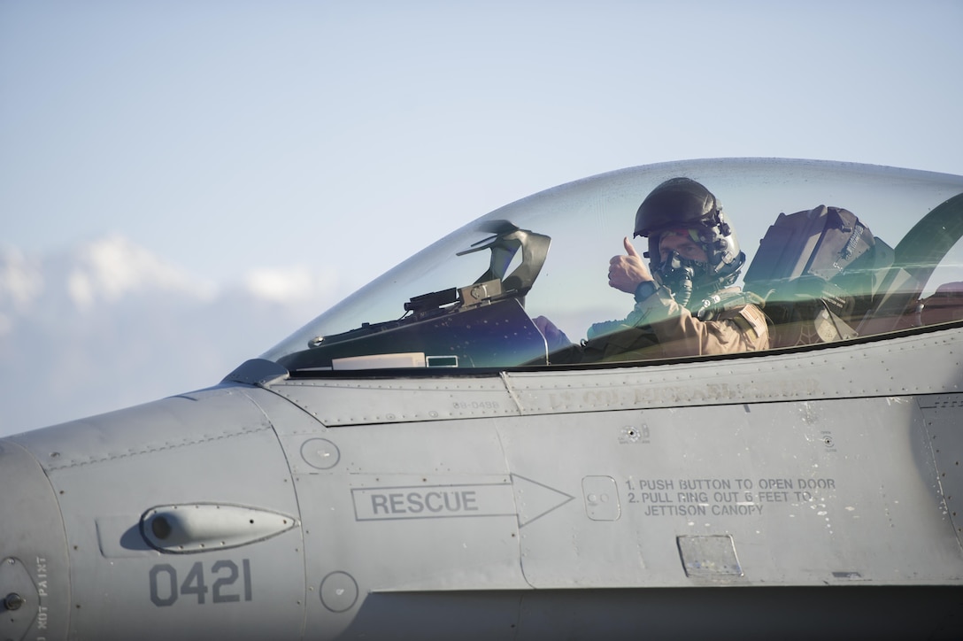 U.S. Air Force Col. Henry Rogers, 421st Expeditionary Fighter Squadron, gives a thumbs up to his crew chief from the cockpit of an F-16 Fighting Falcon aircraft at Bagram Airfield, Afghanistan, Nov. 27, 2015. U.S. Air Force photo by Tech. Sgt. Robert Cloys