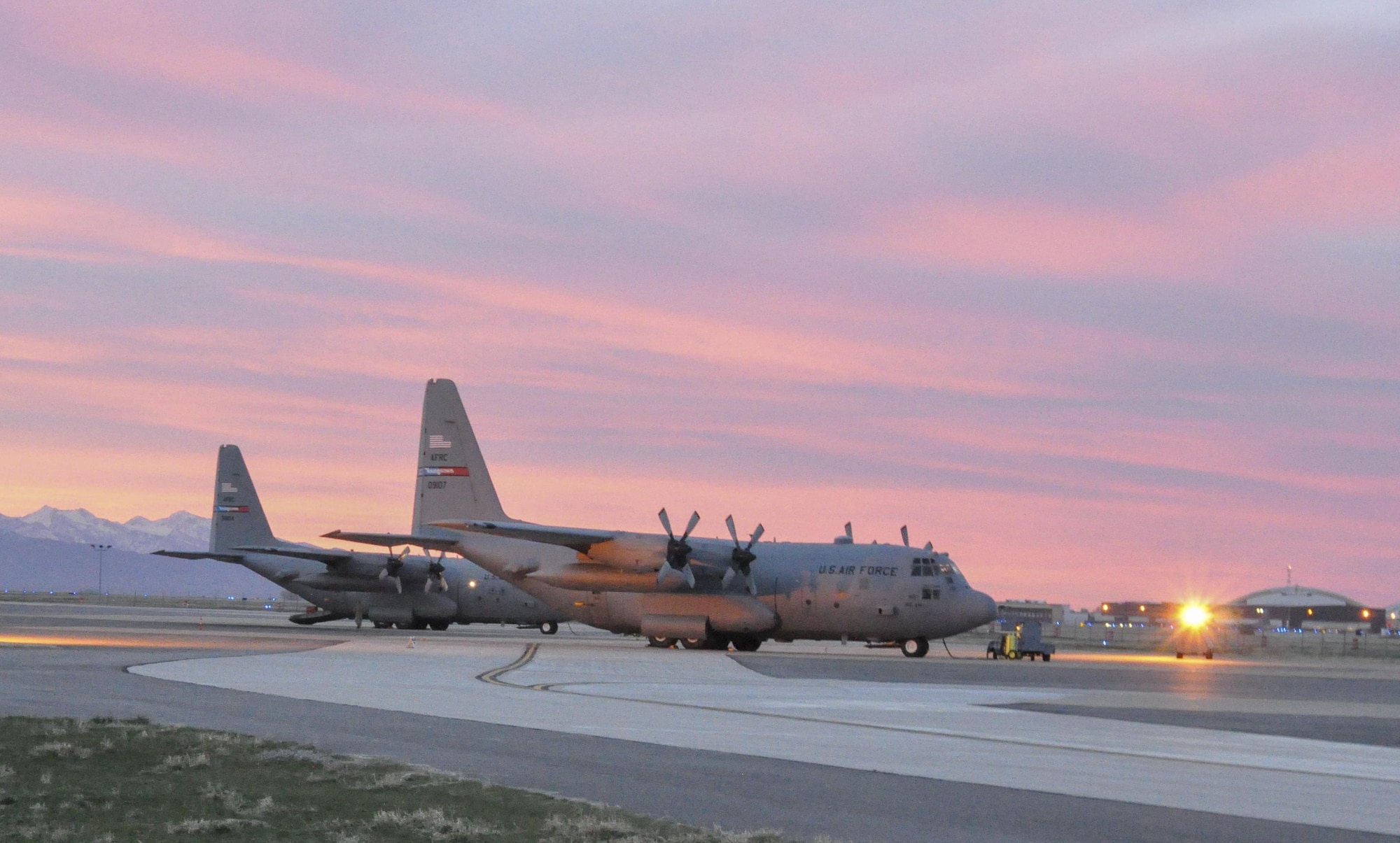 A pair of modified C-130H Hercules tactical cargo aircraft, assigned to the 910th Airlift Wing, sit on the ramp as the sun rises over Hill Air Force Base, Utah, March 17, 2015. The 757th Airlift Squadron's aerial spray flight conducted a two-week aerial spray mission over the Utah Test and Training Range, March 9–20, 2015, to eliminate unwanted invasive weeds. The 910th, based at Youngstown Air Reserve Station, Ohio, is home to the Department of Defense’s only large area, fixed wing aerial spray capability. (U.S. Air Force photo/by Staff Sgt. Rachel Kocin) 
