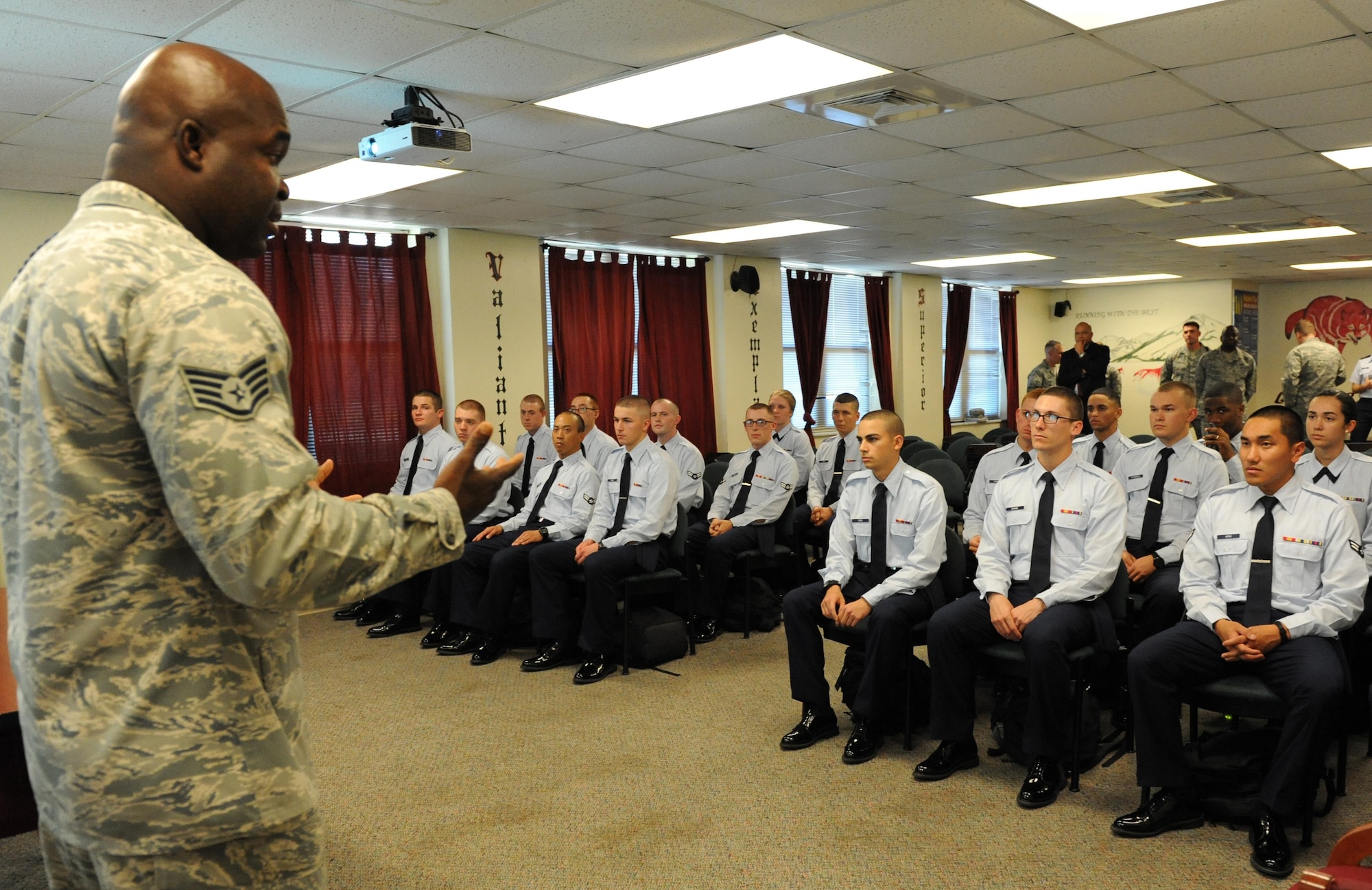 Staff Sgt. Robinson Divert, 334th Training Squadron military training leader, provides a resiliency training session as Senior Executive Service, Chevalier P. “Chevy” Cleaves, Director, Diversity and Inclusion, Deputy Chief of Staff for Manpower, Personnel and Services, Headquarters U.S. Air Force, observes the class during an immersion tour with 2nd Air Force and the 81st Training Wing Nov. 19, 2015, Keesler Air Force Base, Miss.  Cleaves visit included a working lunch with base leadership, a Campaign to Zero brief, and a final formation observation. (U.S. Air Force photo by Kemberly Groue)