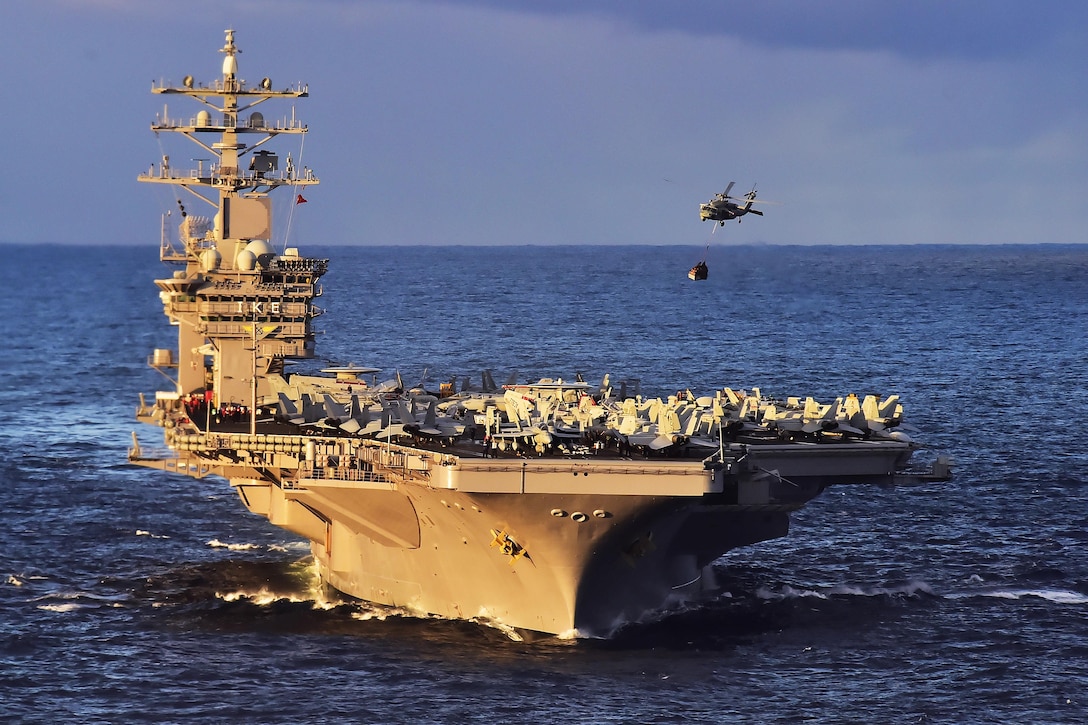 A Navy MH-60S Seahawk delivers cargo to the aircraft carrier USS Dwight D. Eisenhower during a replenishment at sea with the USNS Kanawha in the Atlantic Ocean, Nov. 29, 2015. The Seahawk is assigned to Helicopter Sea Combat Squadron 7. U.S. Navy photo by Petty Officer 3rd Class Jameson E. Lynch