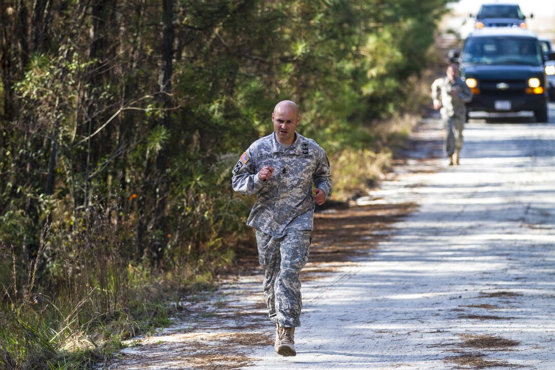 Army 1st Sgt. Ricardo Gutierrez leads the pack as he finishes a 1.5-mile run to the confidence course after finishing a 14-mile road march wearing a 55-pound ruckpack during the assessment phase of the Best Ranger Competition on Fort Jackson, S.C., Nov. 24, 2015. Gutierrez is one of three Fort Jackson soldiers fighting for a position on a two-soldier team that will represent the post during the 33rd annual competition on Fort Benning, Ga., in April 2016. U.S. Army photo by Sgt. 1st Class Brian Hamilton