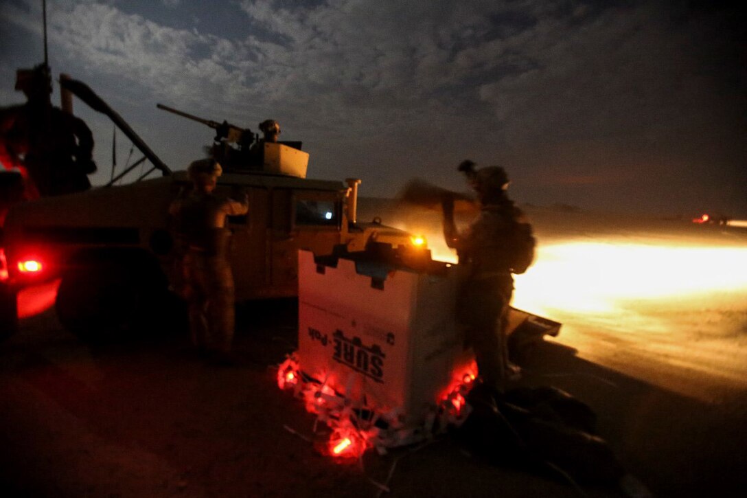 U.S. Marines collect a cargo pallet from an aerial delivery coordinated by Combat Logistics Battalion 1 at an undisclosed location  during a mission readiness exercise in Southwest Asia, Nov. 24, 2015. U.S. Marine Corps photo by Sgt. Rick Hurtado