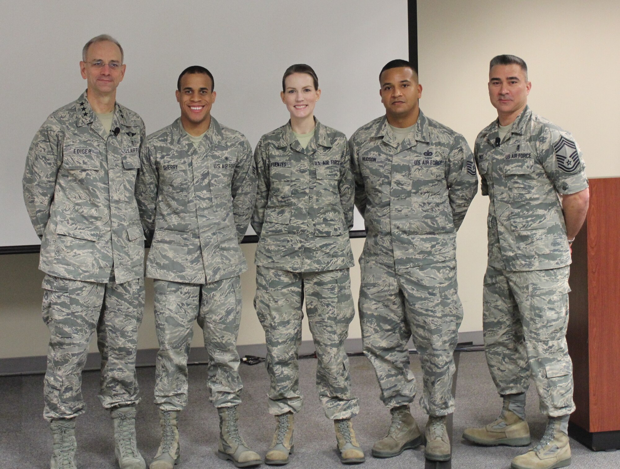 Lt. Gen. Mark Ediger, Air Force Surgeon General, and Chief Master Sgt. Jason Pace, Chief, Medical Enlisted Force, saluted three medical Airmen who earned the Outstanding Airman of the Year Award at the 2015 Senior Leadership Workshop at the National Conference Center in Leesburg, Va., on November 19. From left to right: Lt. Gen. Ediger, Senior Airman Allen R. Cherry III, Staff Sgt. Lindsey H. Fuentes, Tech. Sgt. Troye L Hudson, and Chief Master Sgt. Pace. Both Senior Airman Cherry and Staff Sgt. Fuentes earned the award this year. Tech. Sgt. Hudson earned it last year but was deployed and unable to attend last year's workshop. (Photo by Jon Stock, USAF)
