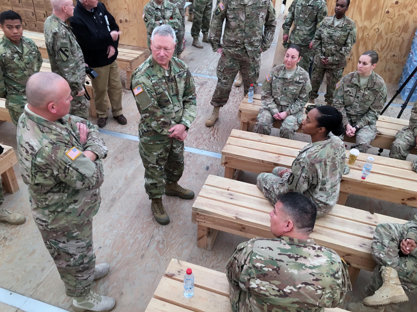 Army Gen. Frank Grass, chief, National Guard Bureau, center, and Air Force Chief Master Sgt. Mitchell Brush, his senior enlisted advisor, left, talk with Texas National Guard members serving at MK Air Base, Romania, in support of Operation Atlantic Resolve and other missions, Nov. 28, 2015. This image was acquired using a cellular phone. 