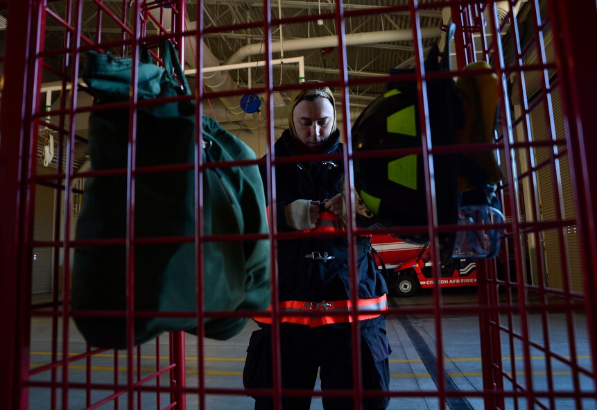 Landon, 99th Civil Engineering Squadron fire fighter, suits up for an exercise Nov. 24, 2015, at Creech Air Force Base, Nevada. The exercise took place at the munitions storage area and included two simulated injuries and a simulated fire on a bomb lift. (U.S. Air Force photo by Airman 1st Class Christian Clausen/Released)
