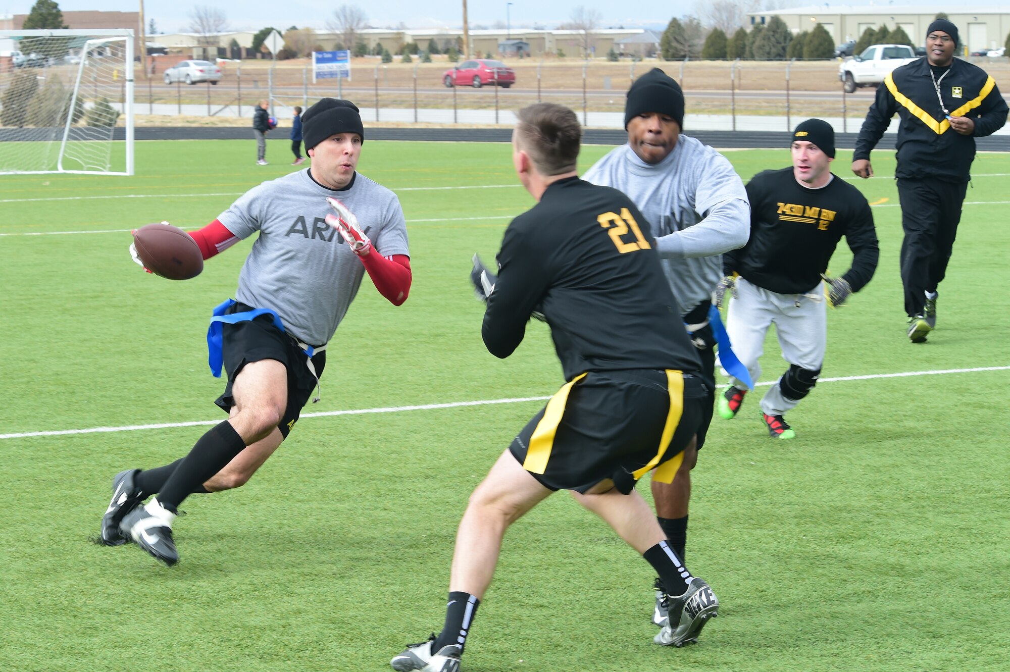 A member of the 743rd Military Intelligence Battalion senior NCOs team makes a cut to avoid a defender Nov. 25, 2015, on Buckley Air Force Base, Colo. The final outcome of the annual 743rd MI Battalion Turkey Bowl game was 24 to 18 with the officers walking away with the victory. (U.S. Air Force photo by Airman 1st Class Luke W. Nowakowski/Released)