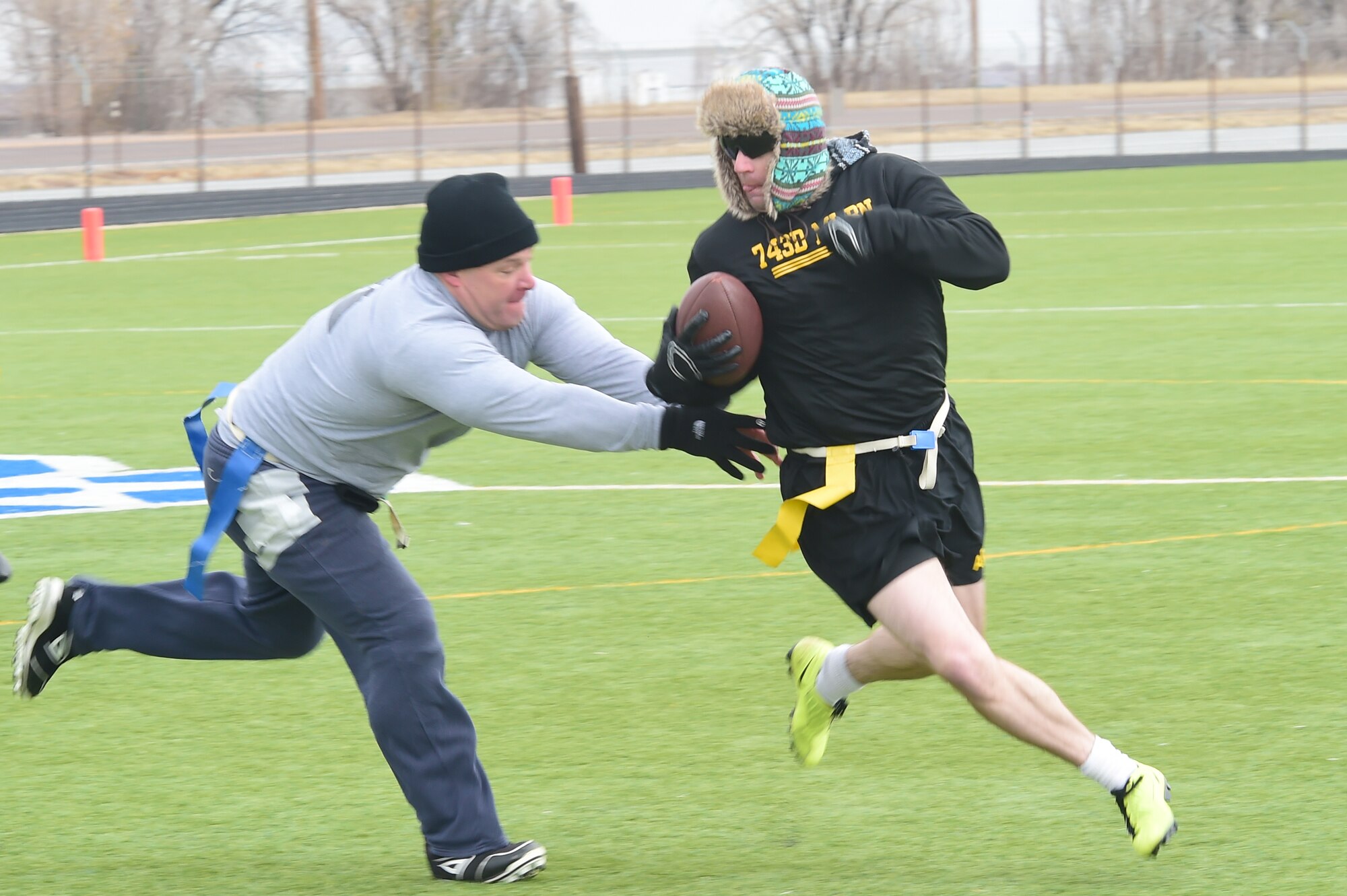 A member of the 743rd Military Intelligence Battalion officer team pulls away from a defender Nov. 25, 2015, on Buckley Air Force Base, Colo. The final outcome of the game was 24 to 18 with the officers walking away with the victory. (U.S. Air Force photo by Airman 1st Class Luke W. Nowakowski/Released)