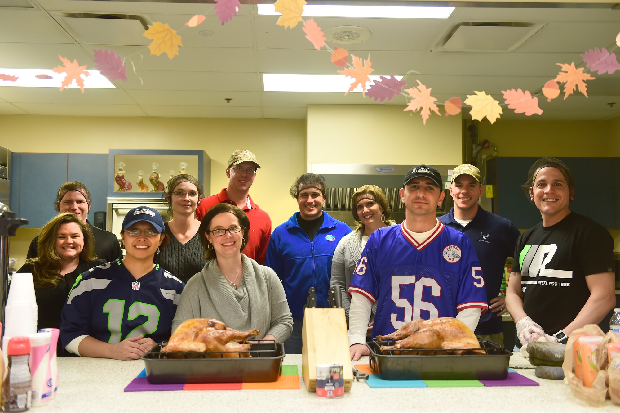 Base leadership, along with members of the Buckley Spouses Group and the Buckley First Sergeants Council, pose for a photo Nov. 26, 2015, on Buckley Air Force Base, Colo. Leadership, along with the two organizations, prepared a Thanksgiving meal for Team Buckley members. (U.S. Air Force photo by Airman 1st Class Luke W. Nowakowski/Released)
