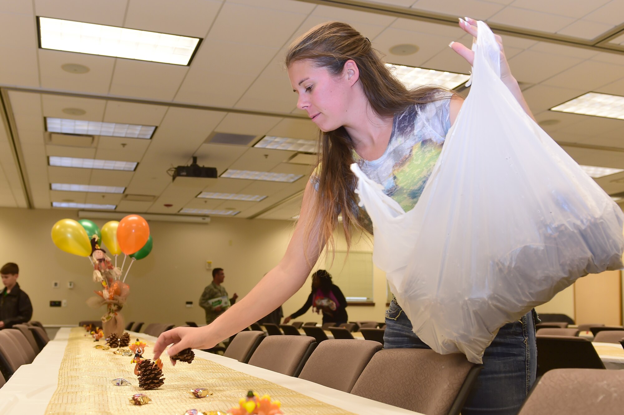 A member of the Buckley Spouses Group sets up table décor for the Thanksgiving meal at the chapel Nov. 25, 2015, on Buckley Air Force Base, Colo. The Buckley First Sergeants Council, Buckley Spouses Group and Buckley Top Three helped organize and put on the Thanksgiving meal for Team Buckley members. (U.S. Air Force photo by Airman 1st Class Luke W. Nowakowski/Released)