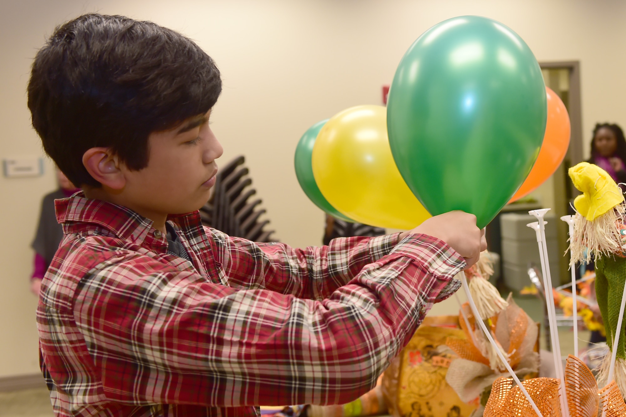 A child from the Buckley community helps set up table displays for the Thanksgiving meal at the chapel Nov. 25, 2015, on Buckley Air Force Base, Colo. The Buckley First Sergeants Council, Buckley Top Three and Buckley Spouses Group helped organize and put on the Thanksgiving meal for Team Buckley members. (U.S. Air Force photo by Airman 1st Class Luke W. Nowakowski/Released)