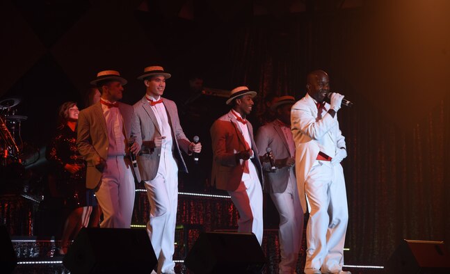 Tops in Blue members perform a 1920s style song during the group’s Nov. 28 performance at the Montana Expo Park in Great Falls, Mont. Since their first world tour in 1953, the group has consistently performed for audiences across the globe to boost military members’ morale and share military history.  (U.S. Air Force photo/Airman Collin Schmidt)
