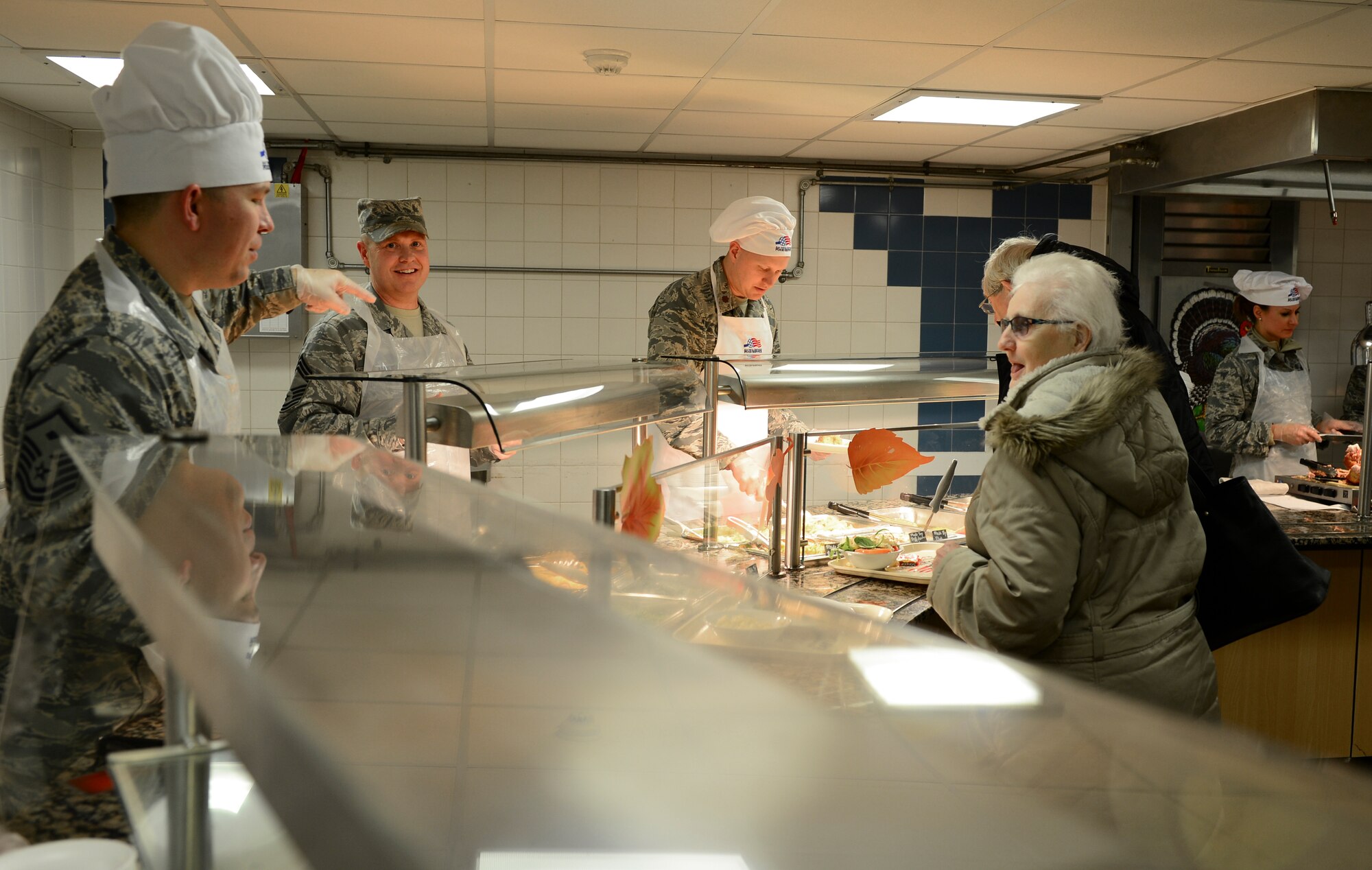 Leadership from around the 48th Fighter Wing served Thanksgiving meals at the Knight’s Table Dining Facility, Nov. 26, 2015 at Royal Air Force Lakenheath, England. The dining facility was open for all Airmen and their families to enjoy a Thanksgiving meal together while away from home. (U.S. Air Force photo by Senior Airman Dawn M. Weber/Released)