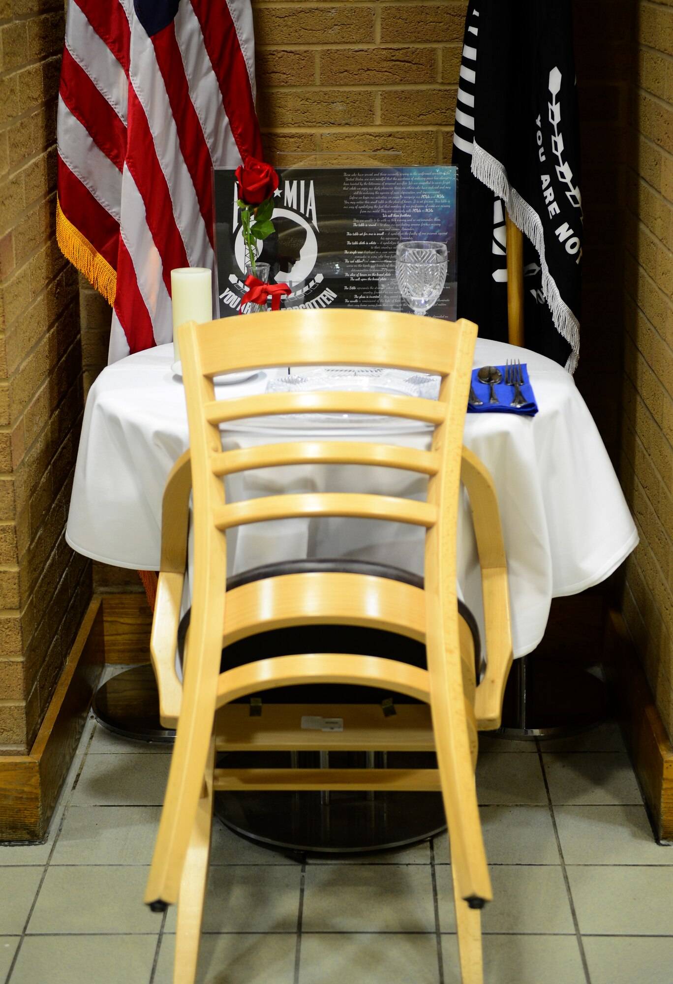 A Missing Man table is set to honor fallen service members at the Knight’s Table Dining Facility, Nov. 26, 2015 at Royal Air Force Lakenheath, England. The table is set as a place of honor during special occasions in memory of fallen, missing or imprisoned military service members.  (U.S. Air Force photo by Senior Airman Dawn M. Weber/Released)
