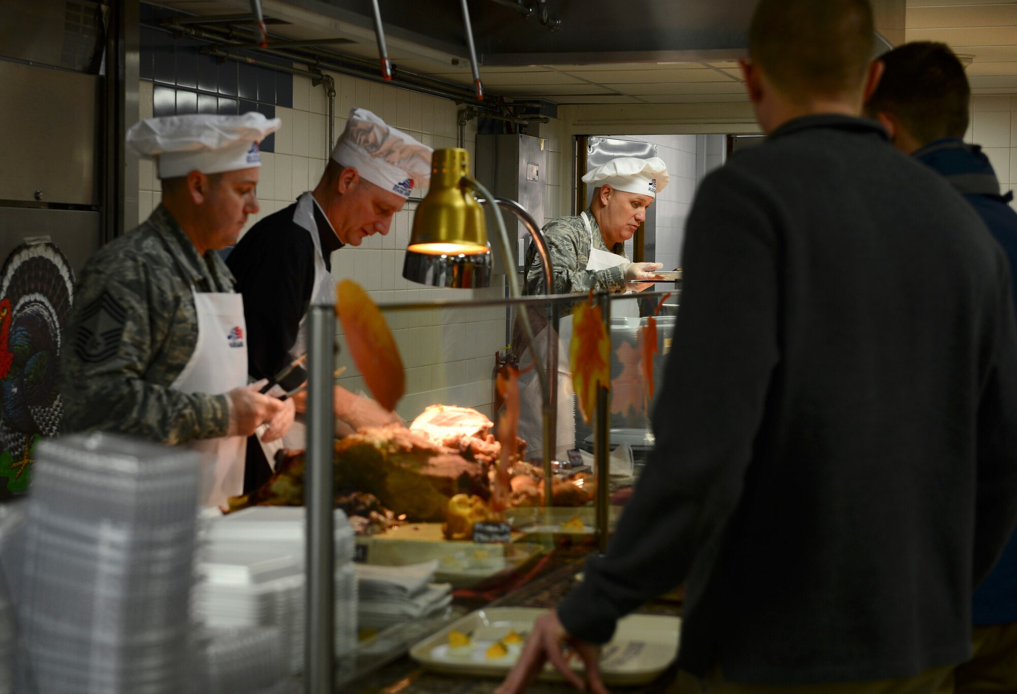 Leadership from around the 48th Fighter Wing served Thanksgiving meals at the Knight’s Table Dining Facility, Nov. 26, 2015 at Royal Air Force Lakenheath, England. Each year wing leadership typically volunteer to serve a holiday meal to Airmen and their families and wish everyone a safe and happy Thanksgiving. (U.S. Air Force photo/Senior Airman Dawn M. Weber/Released)